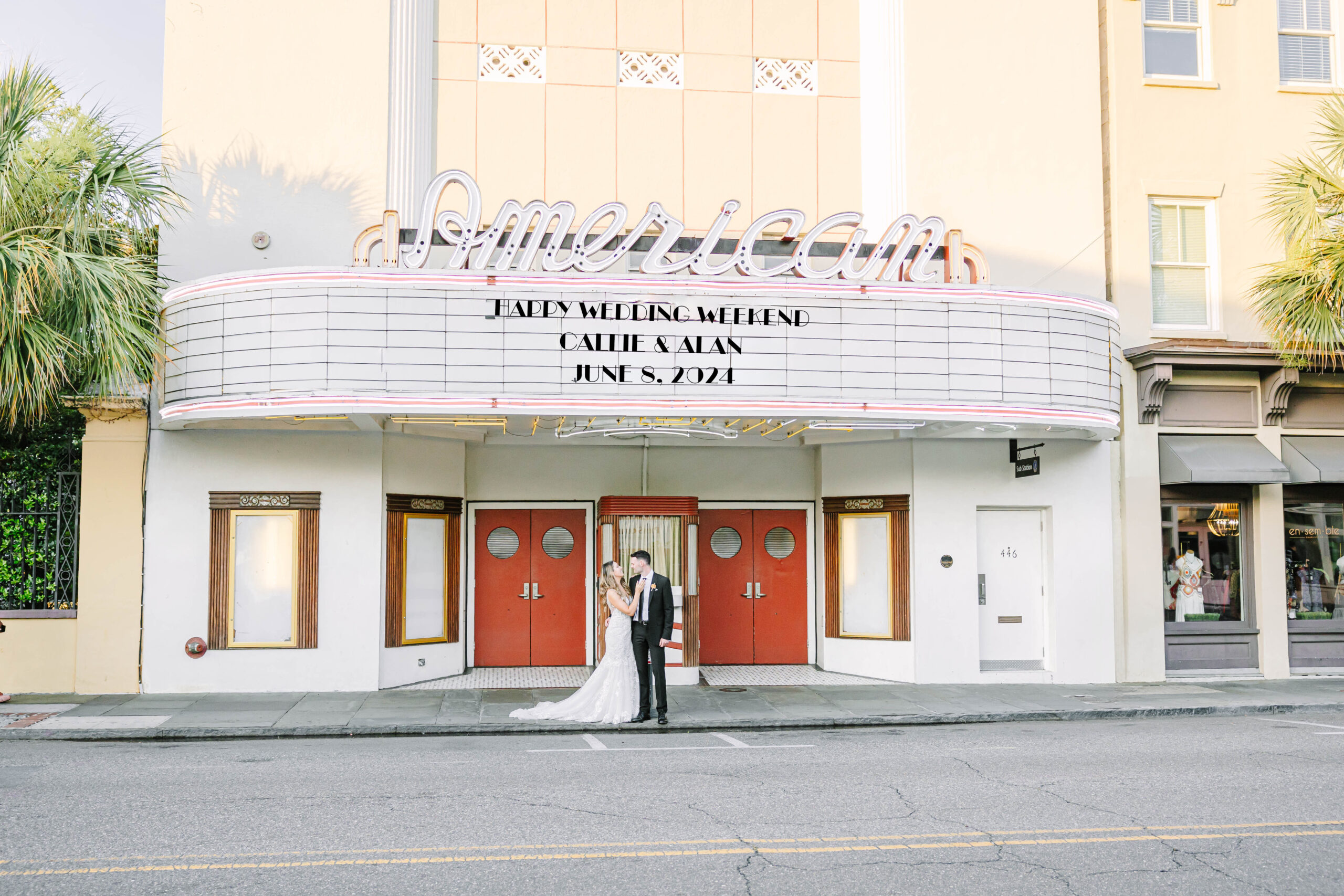 bride and groom in front of american theater charleston south carolina